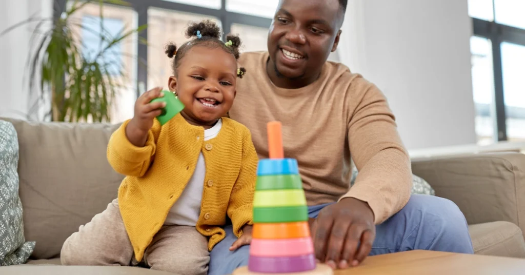 Daily Routines for Preschoolers. Child playing toys with her father. Simple daily routines for preschoolers that reduce stress, improve behavior, and help families enjoy calmer days at home.