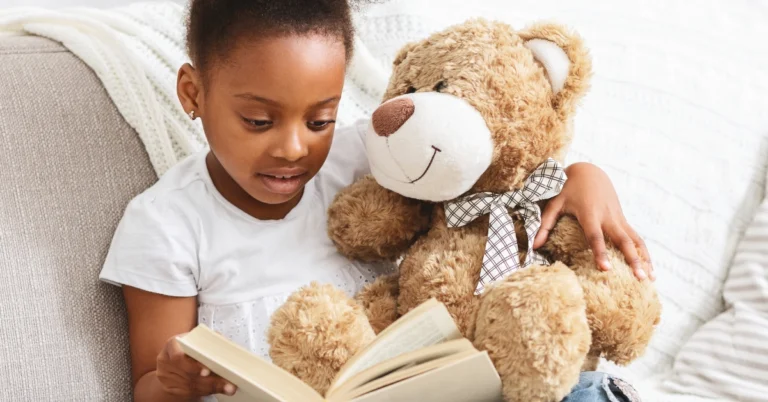 Little girl reading to her teddy bear - Learn counting with The Zinghoppers' "Five Teddy Bears" song—includes fun activities, crafts, and educational benefits for toddlers and preschoolers learning numbers through music.