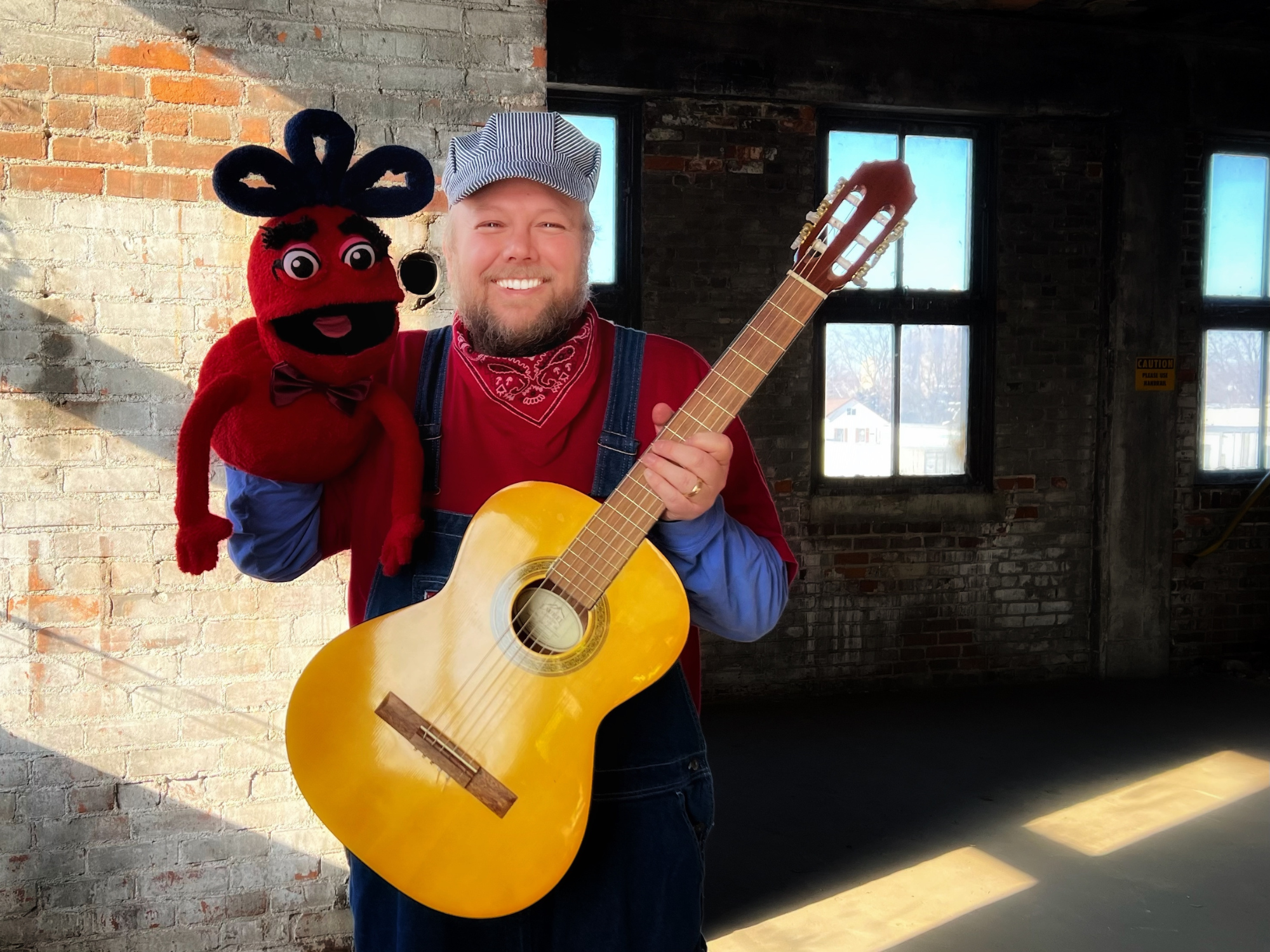Children's musician and educator Conductor Jack with his puppet friend Naybob