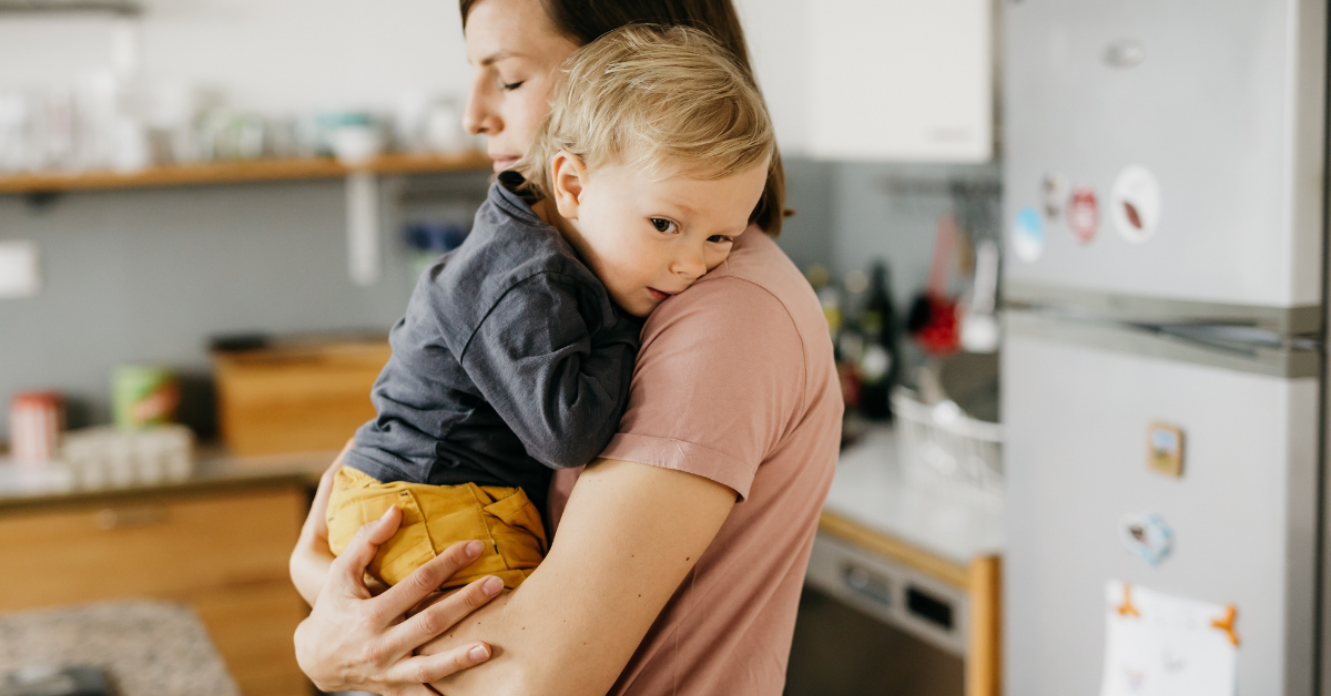 Mom gives toddler a hug