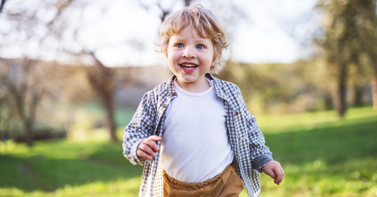 Happy toddler running outdoors
