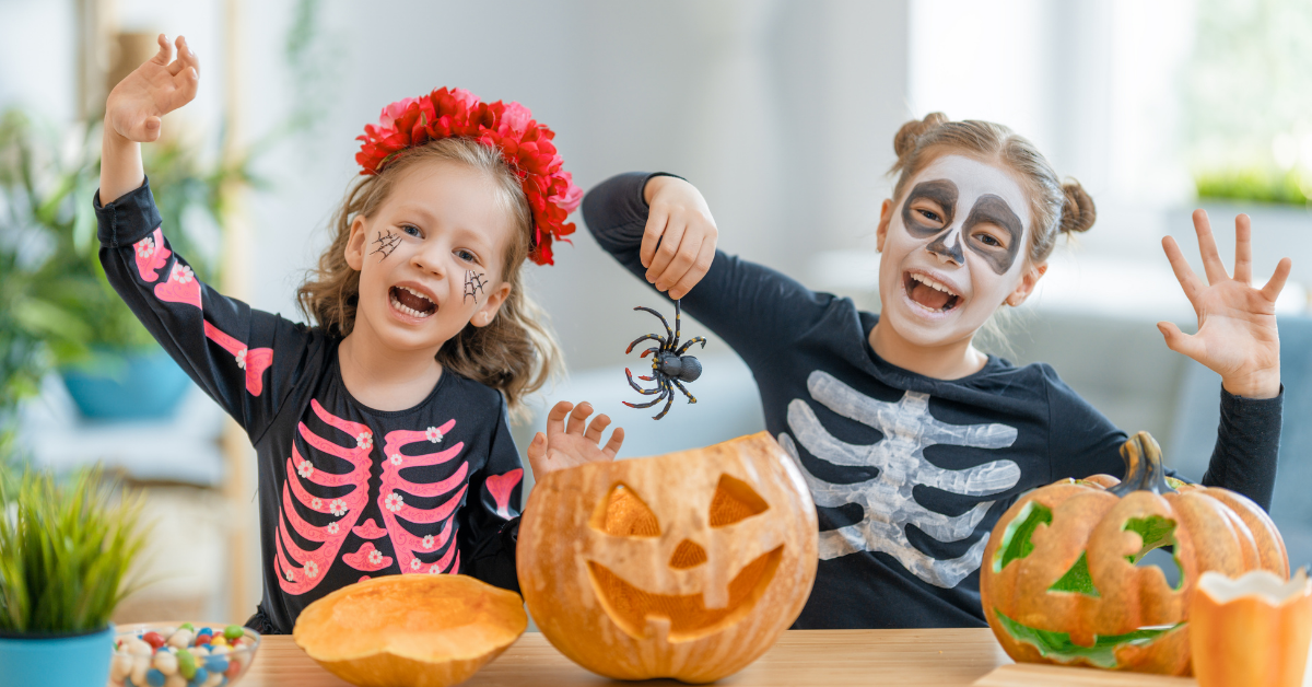 Two kids carving pumpkins for Halloween. Top 10 Halloween Jokes for Kids