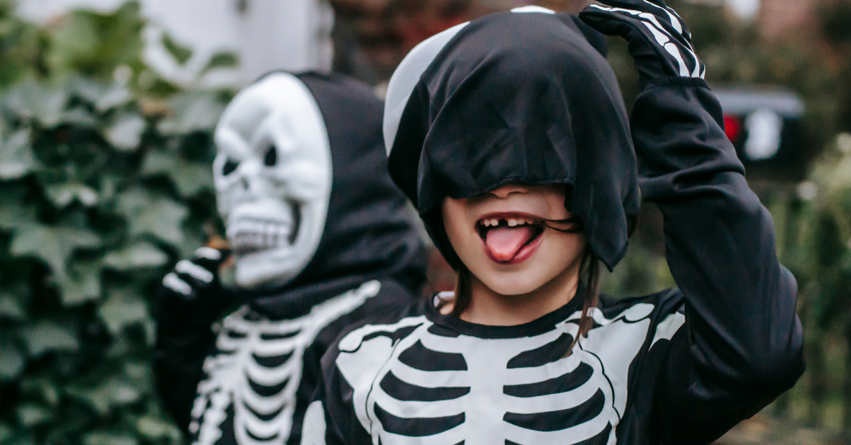 Kids in Halloween skeleton costume