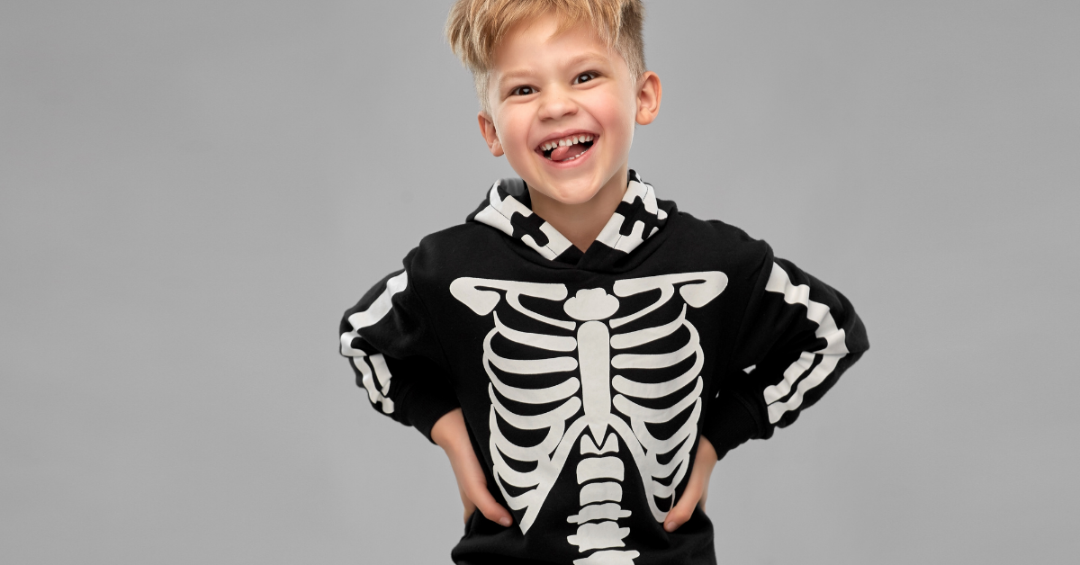 Kid in Halloween skeleton costume